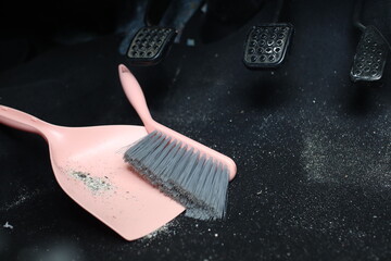 use broom and trash shovel to clean in the carpet area under the accelerator pedal and car coupling