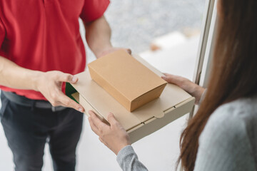 Client receiving lunch box from delivery man at home.