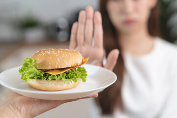 Close-up hands of a people reject to eat fast food for good health
