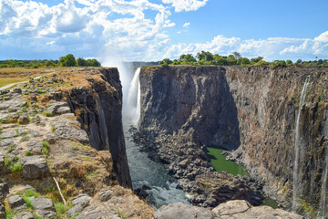 Parts of Mosi-Oa-Tunya waterfall aka Victoria Falls, during the dry season, view from the Zimbabwe side. - obrazy, fototapety, plakaty