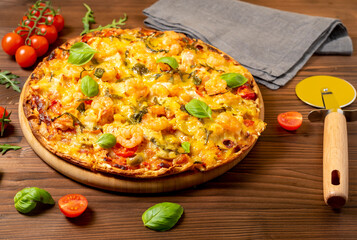 Mediterranean pizza Marinara, with seafood, shrimp and salmon on a wooden background.