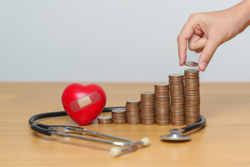 Money Saving, Health Insurance, Medical, Donation and Financial concepts. coins stack with stethoscope and Heart, Money stack Counting arrangement for deposit and Healthcare cost