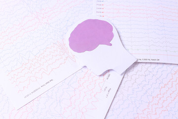 Brain paper cutout on background of brain waves from electroencephalography. Medical record for...