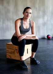 Naklejka premium Workout, sitting and portrait of woman relax after bodybuilding exercise, sports performance or gym training. Athlete lifestyle, motivation and healthy person with fitness progress satisfaction