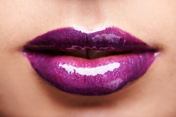 Woman lips, purple lipstick and shine with makeup and beauty closeup, glossy cosmetics product and...