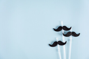 Curly mustaches on colorful background. Fake mustache. Top view