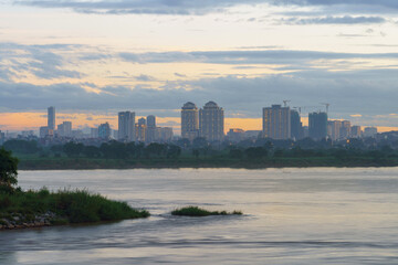 Red River (song Hong) landscape at sunset with Nhat Tan bridge on background in Hanoi, Vietnam