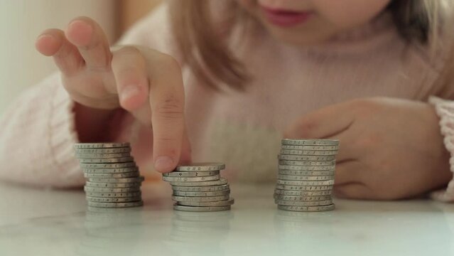 A child counts 2 euro coins