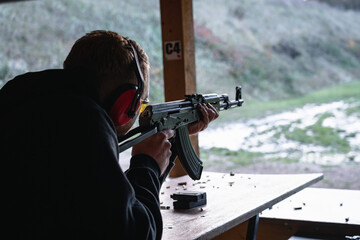 Training shooting weapons at an outdoor shooting range.