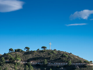 Obraz premium Summit of Monte de la Cruz de Benidorm, mountain of the Sierra Helada mountain range with summit cross, in Benidorm, Alicante, Spain
