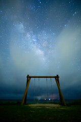 beautiful stars with the milky way and a swing in Kohamajima, Okinawa, Japan