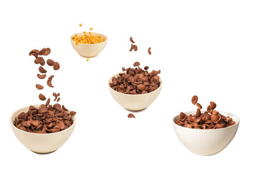 Chocolate corn flakes falling to the white bowl isolated on white. Motion.