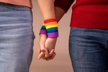 romantic lesbian lover wear lgbt rainbow wristband hands holding support each others, concept of...