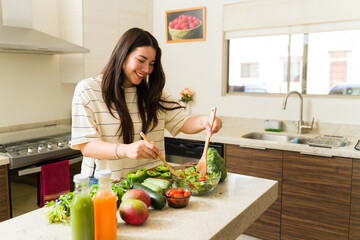 Cheerful vegan woman cooking a vegetarian healthy recipe