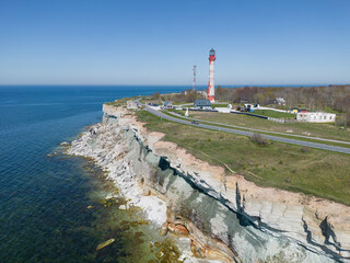 Sea cliff and old lighthouse on the Paldiski peninsula on a summer day.
