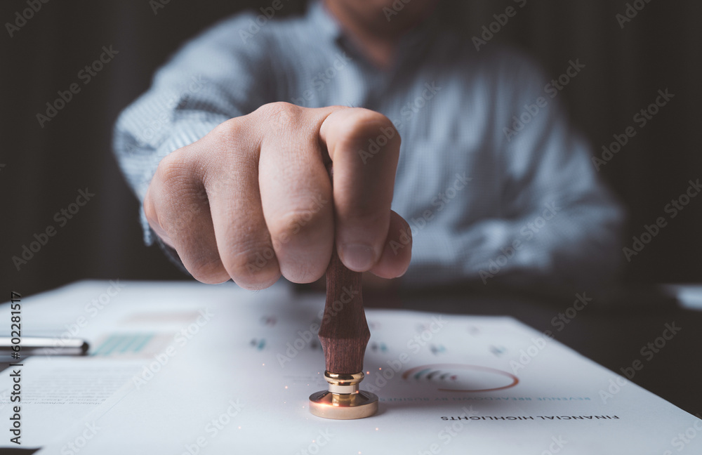 Poster closeup of businessman hand stamping approve project and quality document on desk , certificate and 