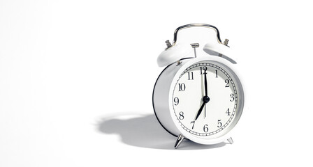 White alarm clock on a white background isolated, close-up.