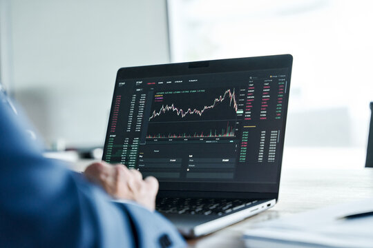 Crypto investor analyst broker analyzing financial stock trade stockmarket exchange platform indexes digital chart data on computer screen thinking of stockmarket invest analytics risk. Over shoulder