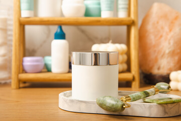 Care cosmetics on the shelf in the bathroom. Cosmetic tube. Cleanser, face and body cream, face roller and gua sha, tonic. Shelf with cosmetics in the interior of the bathroom.Beauty concept.