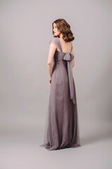 Elegant purple sleeveless evening transformer dress with back bow, rear view. Beautiful full length...