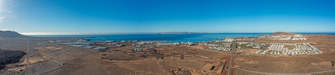 Drone panorama over Playa Blanca vacation village in Lanzarote