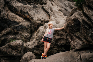 Portrait of a young woman among the rocks, mountains. young traveler