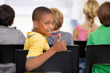 Portrait, black child and thumbs up of student in classroom, elementary school or class. Smile, education and kid with hand gesture for like emoji, agreement and learning, success and approval sign.
