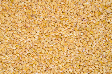 The Top view of dry golden flax seed background