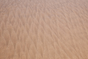 wave pattern background at the beach formerd by wind