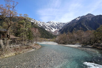 The clear Azusa River and snow-capped Mount Hotaka viewed from Kappa-bashi in Kamikochi, Japan