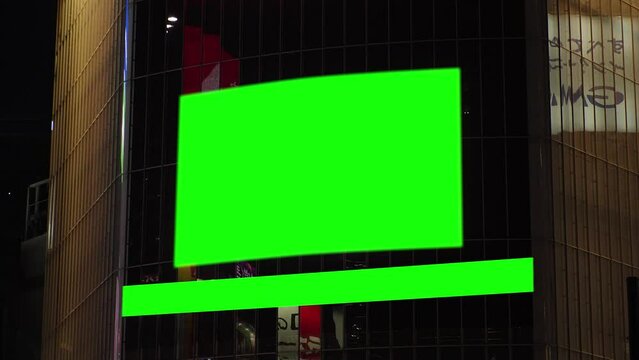 SHIBUYA, TOKYO, JAPAN : Green chroma key background screen at SHIBUYA SCRAMBLE CROSSING. Billboard, logo and advertisement in downtown city.  4K Video for composition.