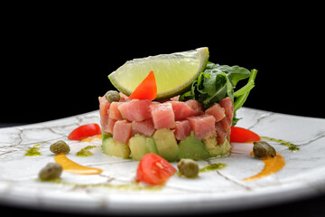 Salmon tartare with avocado and lime on a plate
