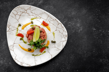 Salmon tartare with avocado and lime on a plate