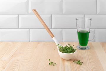 The concept of a healthy lifestyle and diet, eco-product. Preparation of a drink with sprouts, vegetable fresh microgreens Raw sprouts for vitgrass.