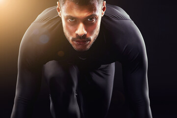 Runner man, start and isolated portrait or run, race and intense focus in dark studio background....