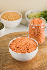 Red raw lentils in a bowl. The concept of vegetable protein. Horizontal photo.