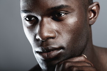 Beauty, skin care and face of black man on dark background with male cosmetics, strong and serious glow closeup. Health, wellness and dermatology, African skincare model isolated on studio backdrop.