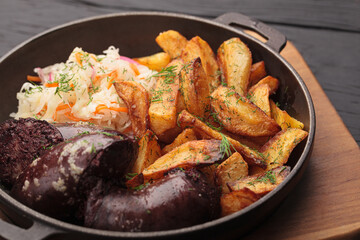 Fried blood sausages with potatoes and various ingredients