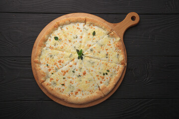 Italian or French pizza with different ingredients. Sausage, meat, cheese, tomatoes.