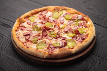 Italian or French pizza with different ingredients. Sausage, meat, cheese, tomatoes.