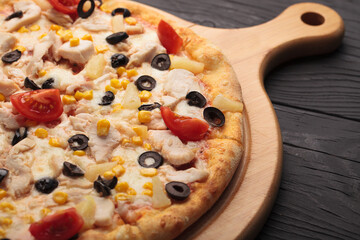 Italian or French pizza with different ingredients. Sausage, meat, cheese, tomatoes.