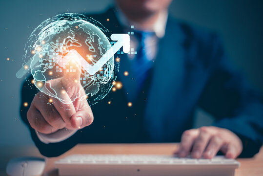 Businessman touching the virtual reality globe and rising bar chart graph as holographic button. Business people and Innovative technology concept.