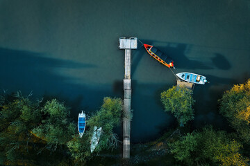 Top view of touristic boats on river at sunset