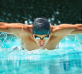 Water splash, sport and training with man in swimming pool for competition, workout and energy. Strong, fitness and cardio with male swimmer and practice for athlete, championship and race at gala