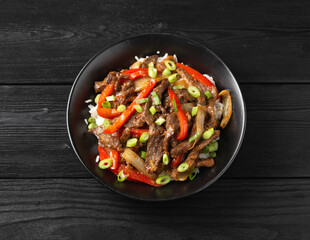 Stir fry Crispy Orange Beef with sweet peppers, onion and rice. Asian food