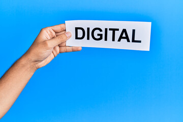 Hand of caucasian man holding paper with digital word over isolated blue background