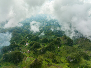 Aerial view of mountain peaks and hills covered with green vegetation and mist. Osmena Peak. Mountain landscape. Cebu Philippines.
