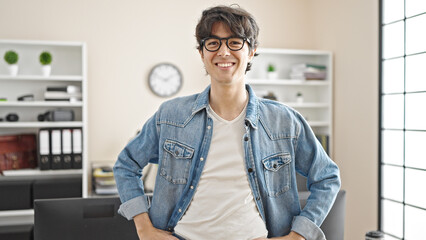 Fototapeta premium Young hispanic man business worker smiling confident at office