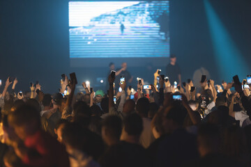 Fototapeta na wymiar People shoot a concert on their phone cameras