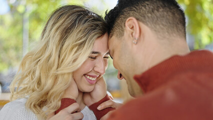 Fototapeta premium Man and woman couple smiling confident hugging each other at park